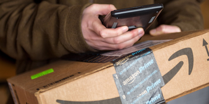 UPS worker handling Amazon box