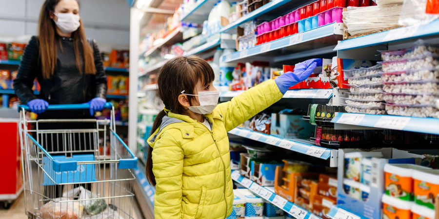 mother and daughter wearing masks and gloves and shopping