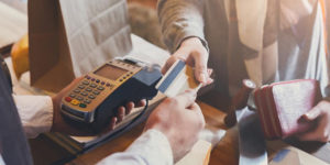 Shopper handing credit card to cashier