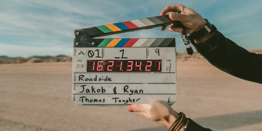 Close-up of hands holding a film clapper board