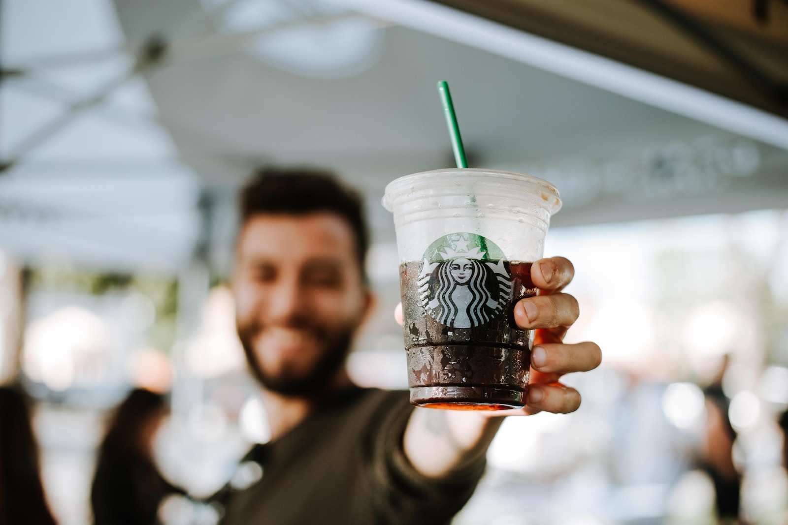 man holding Starbucks cup starbucks union proxy
