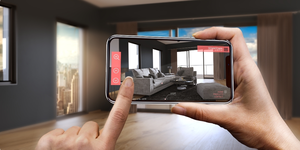 A close-up of someone touching their phone and using AR to test how furniture would look in an empty room