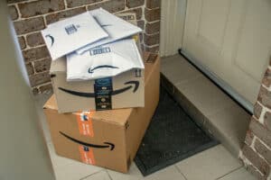 Amazon haul prime boxes and envelopes delivered to a front door of residential building