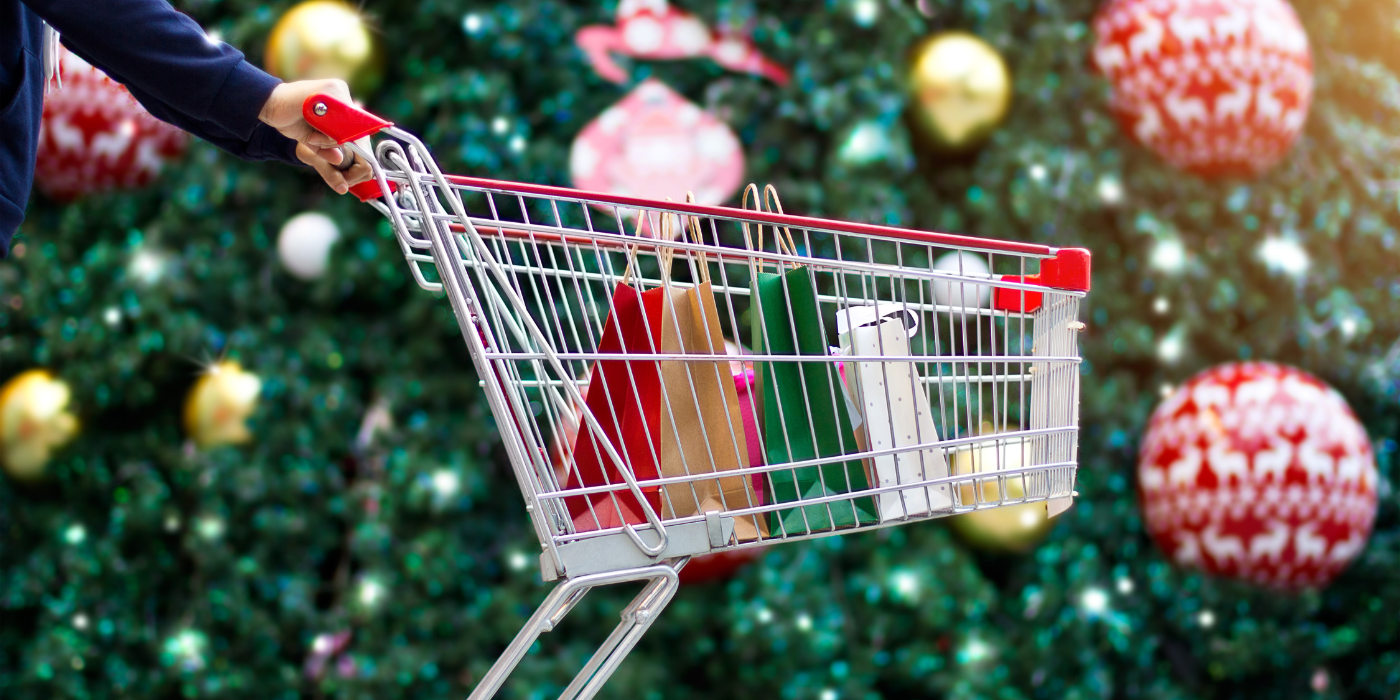 Shopping cart in front of a Christmas tree