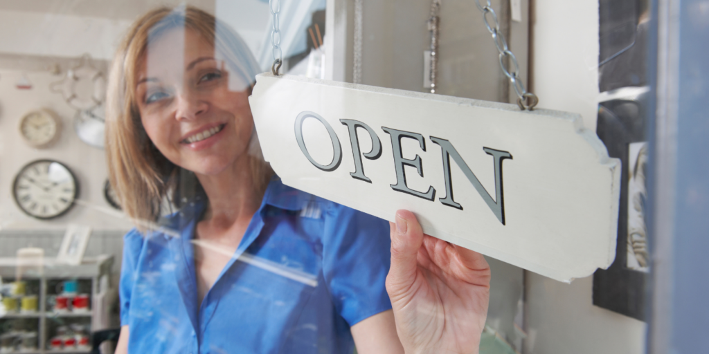 Woman with an "open" sign