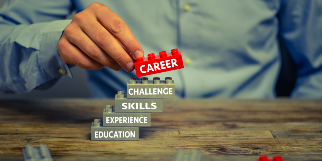 Close-up of a person stacking Lego blocks, with the top one saying "Career" on the side
