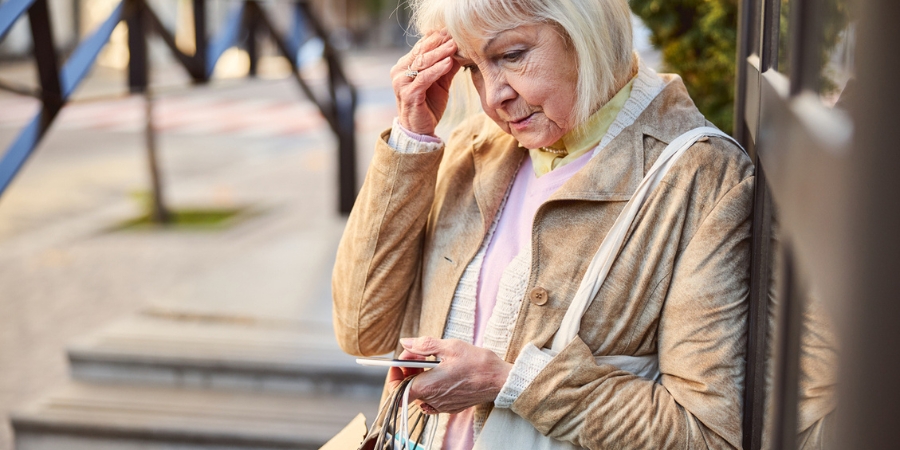 Confused Senior Citizen Shopper Looking at Phone