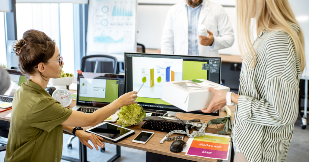 Two women looking and pointing at a computer screen