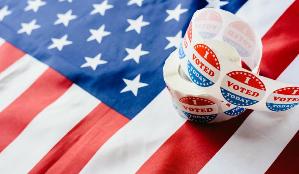 American flag with I voted stickers on top
