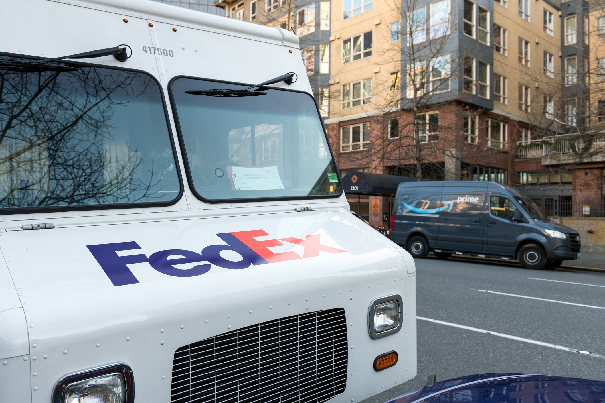 FedEx and Amazon trucks