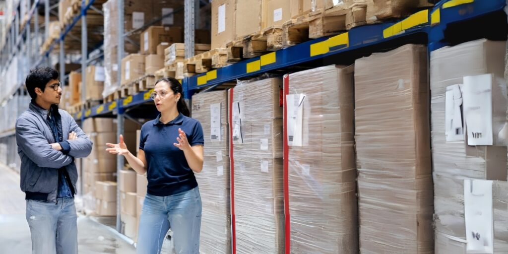 A room full of inventory with two people having a discussion