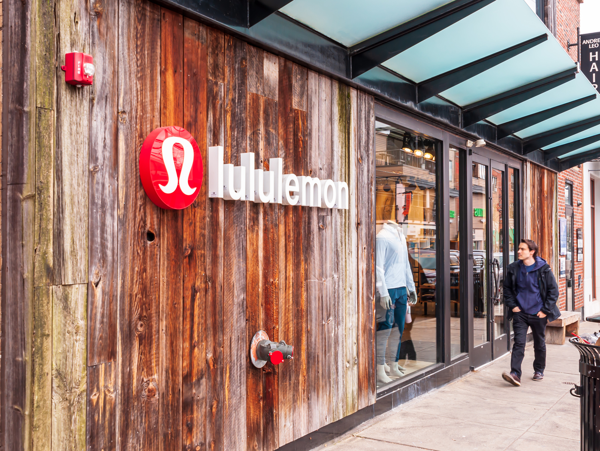 The Lululemon store on Walnut street in the Shadyside neighborhood with a man walking in front of it