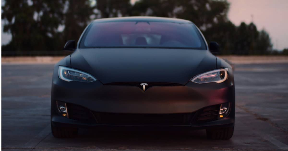 A Tesla driving at night
