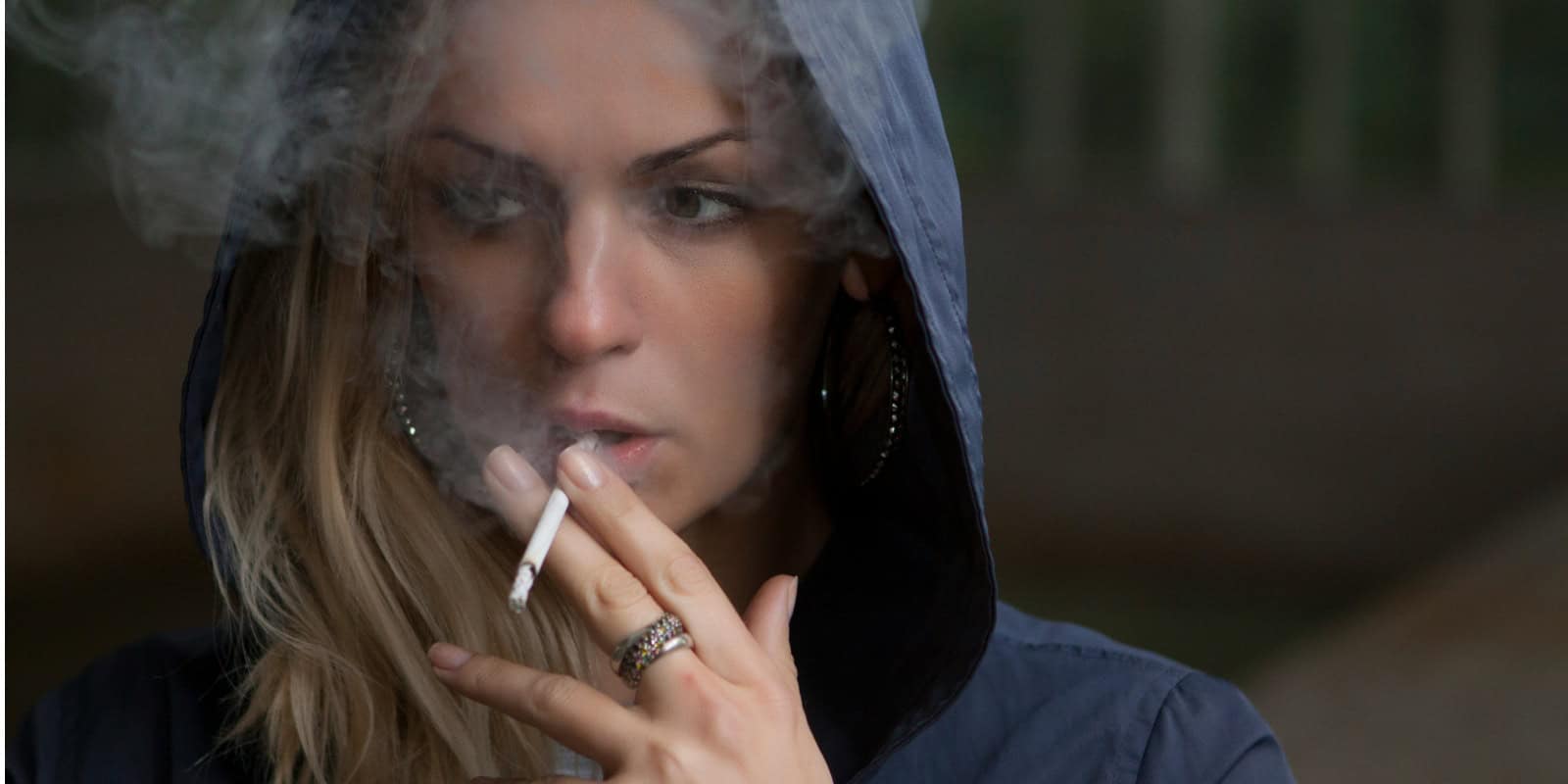 A photo of a woman smoking a cigarette, nicotine