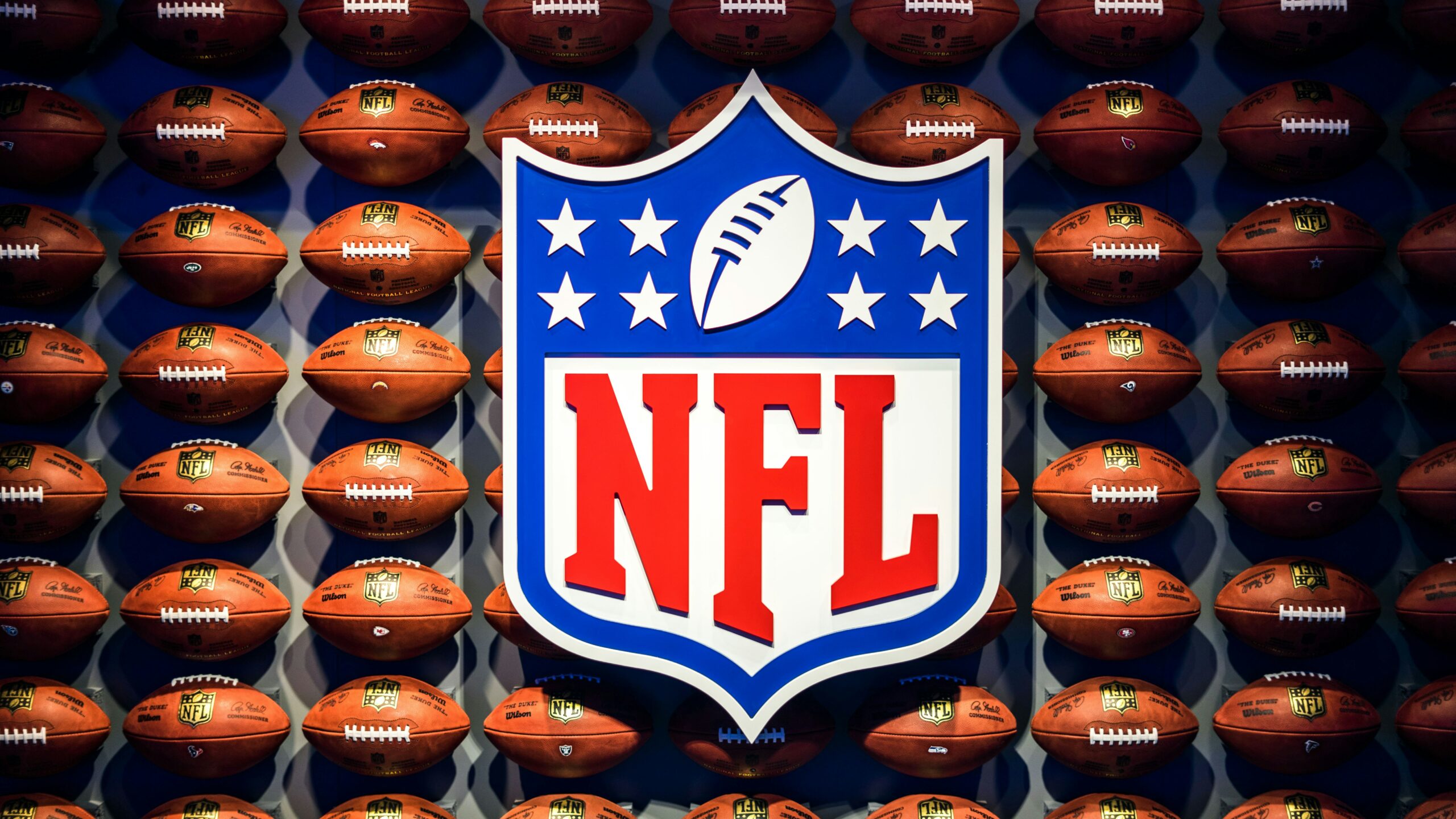 NFL sing in front of footballs