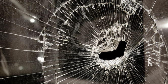 Shattered Glass Window of Abandoned Business in Bad Economy