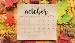 October calendar with leaves behind it