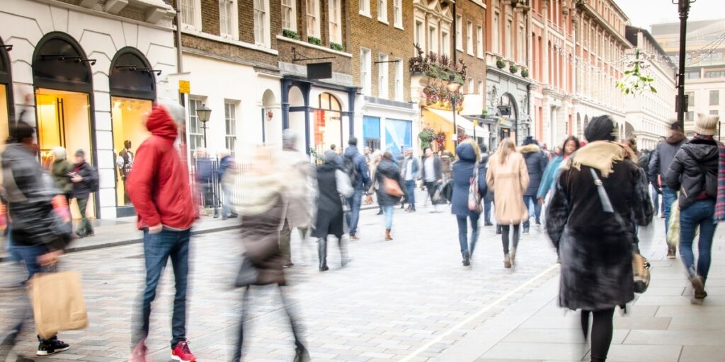 A crowd of people walking on a street