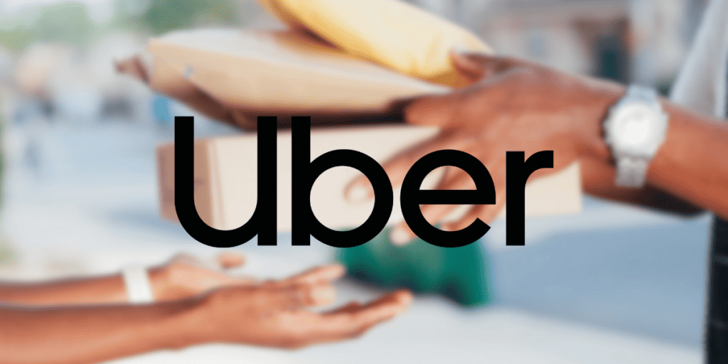 The word "Uber" over a blurred image of a person handing packages to another person