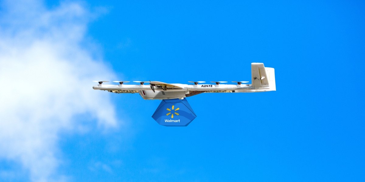 Drone holding a Walmart delivery in the sky
