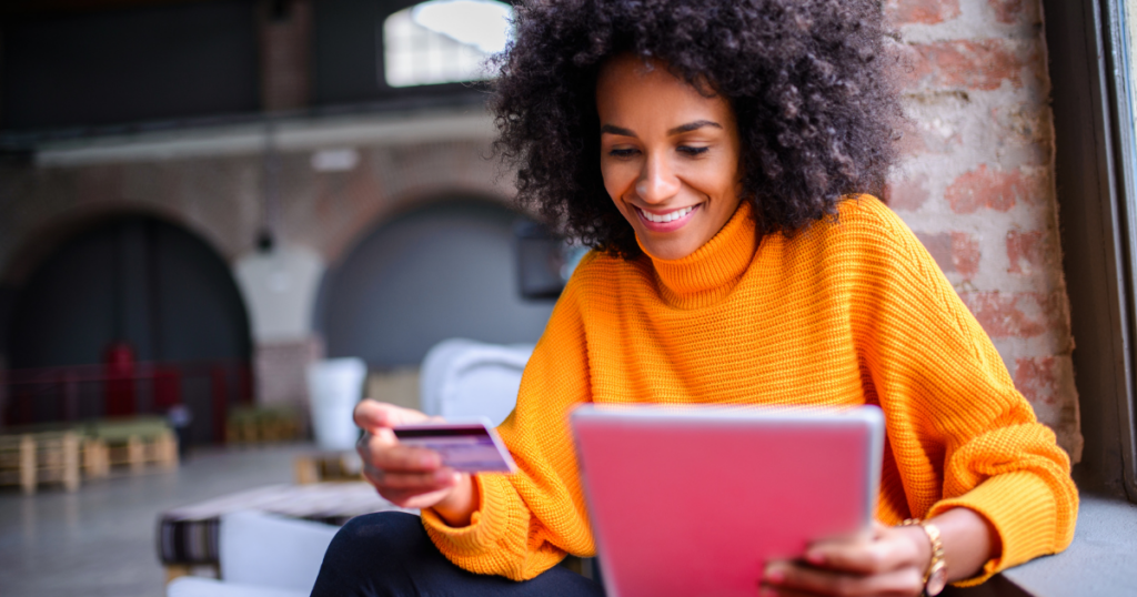 Woman holding a tablet and credit card