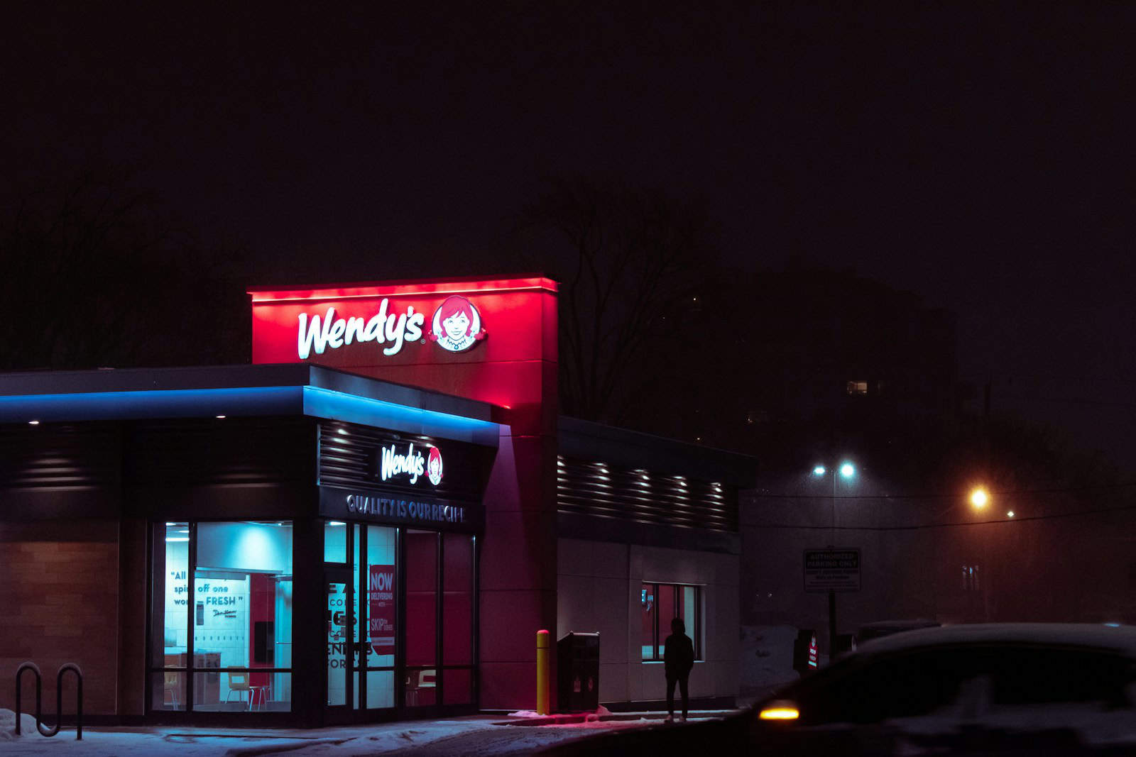 red and white concrete building during nighttime wendy's