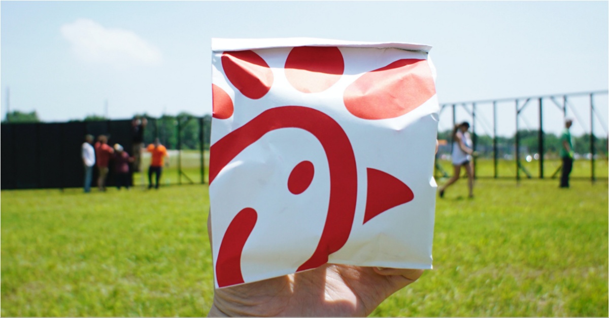 A photo of a person holding a bag of Chick-fil-A.