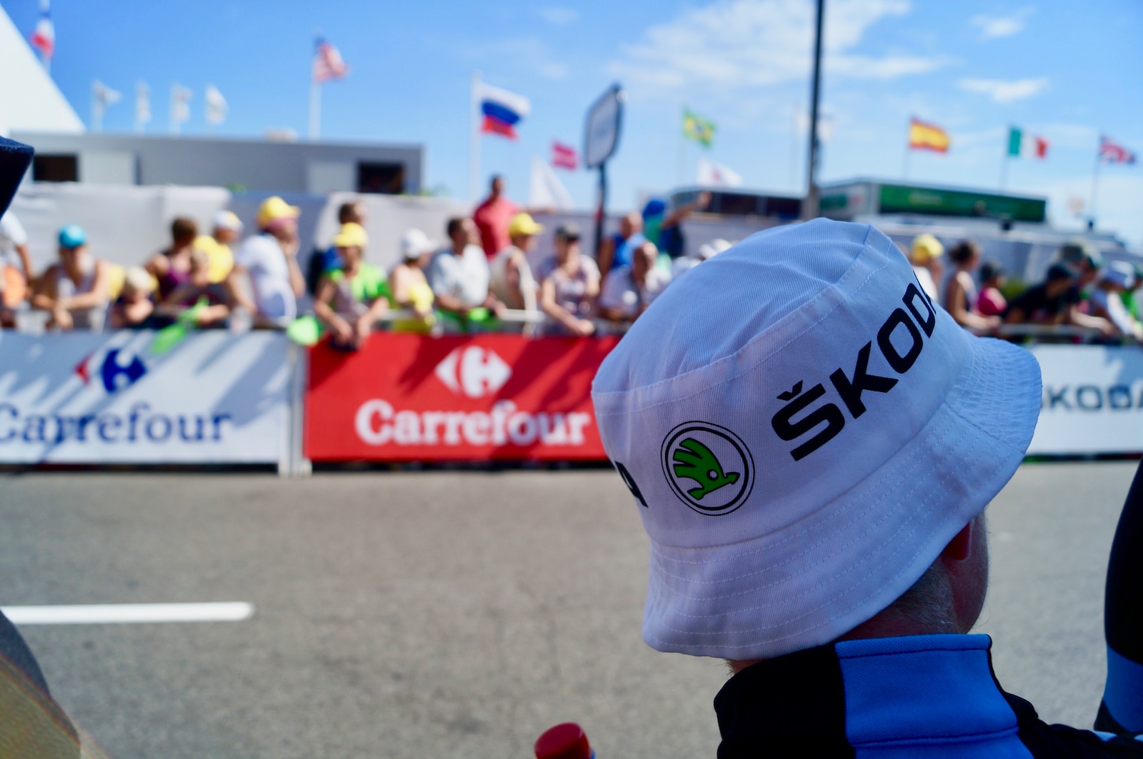 man wearing white hat with carrefour banner