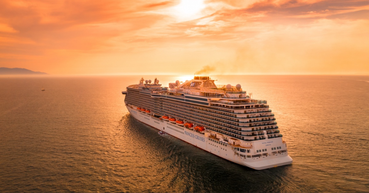 A cruise ship sails into the sunset.