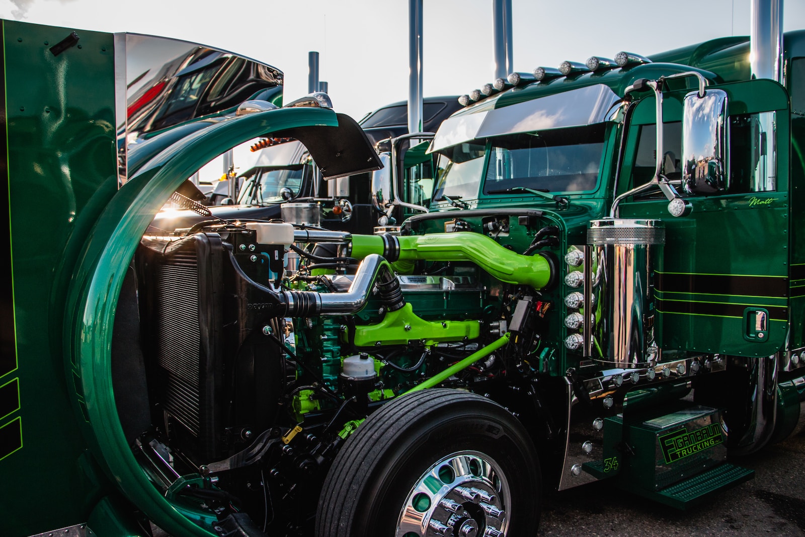 a close up of the front of a green semi truck cummins proxy