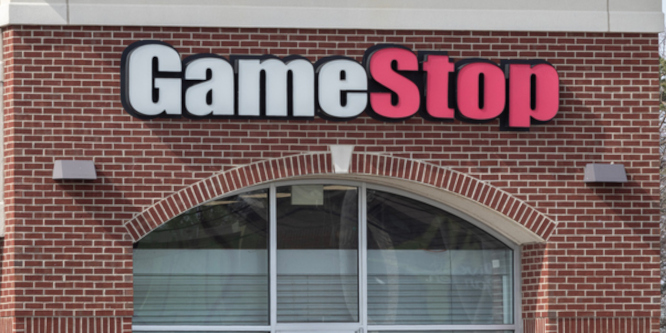 image of GameStop storefront showing logo sign above the top portion of a large window
