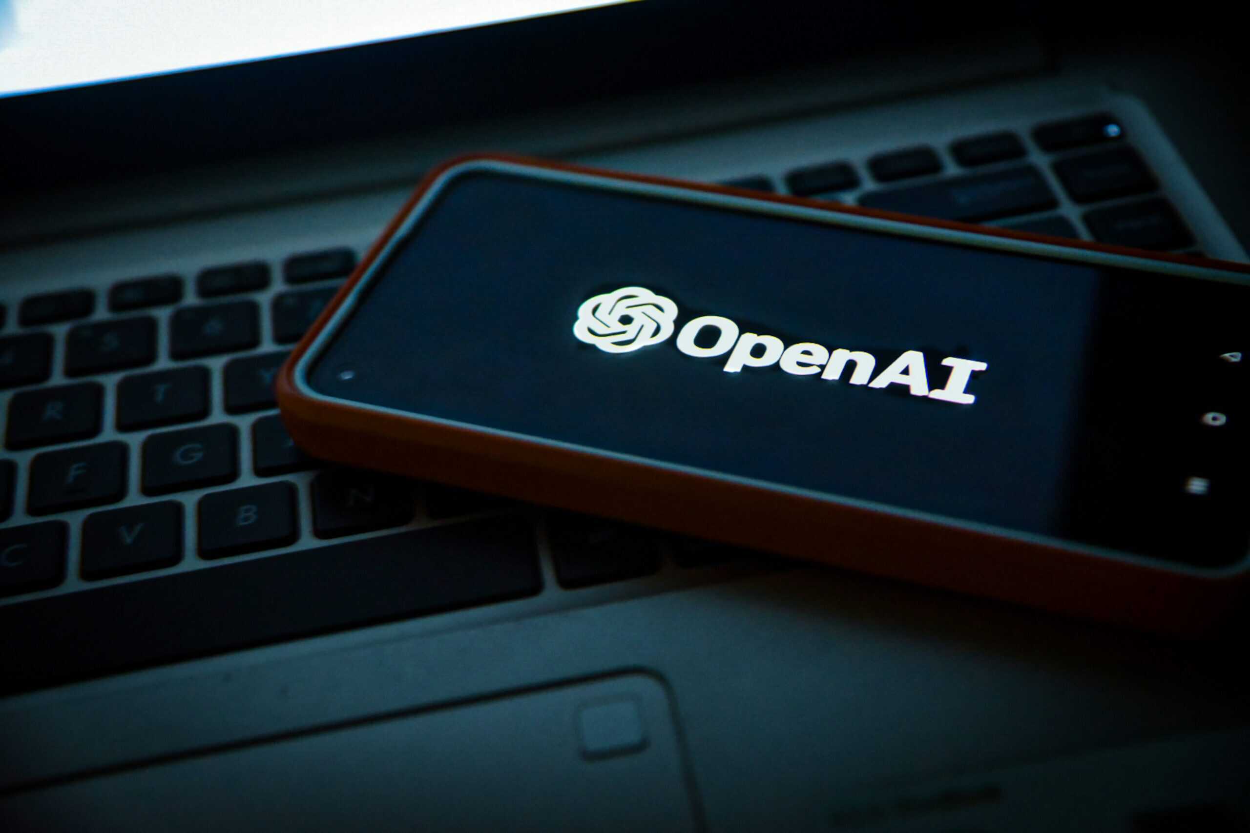 OpenAI logo on laptop keyboard, deep research