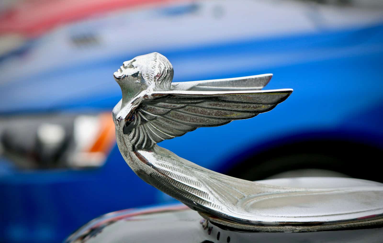 chrome angel car emblem shallow focus photography