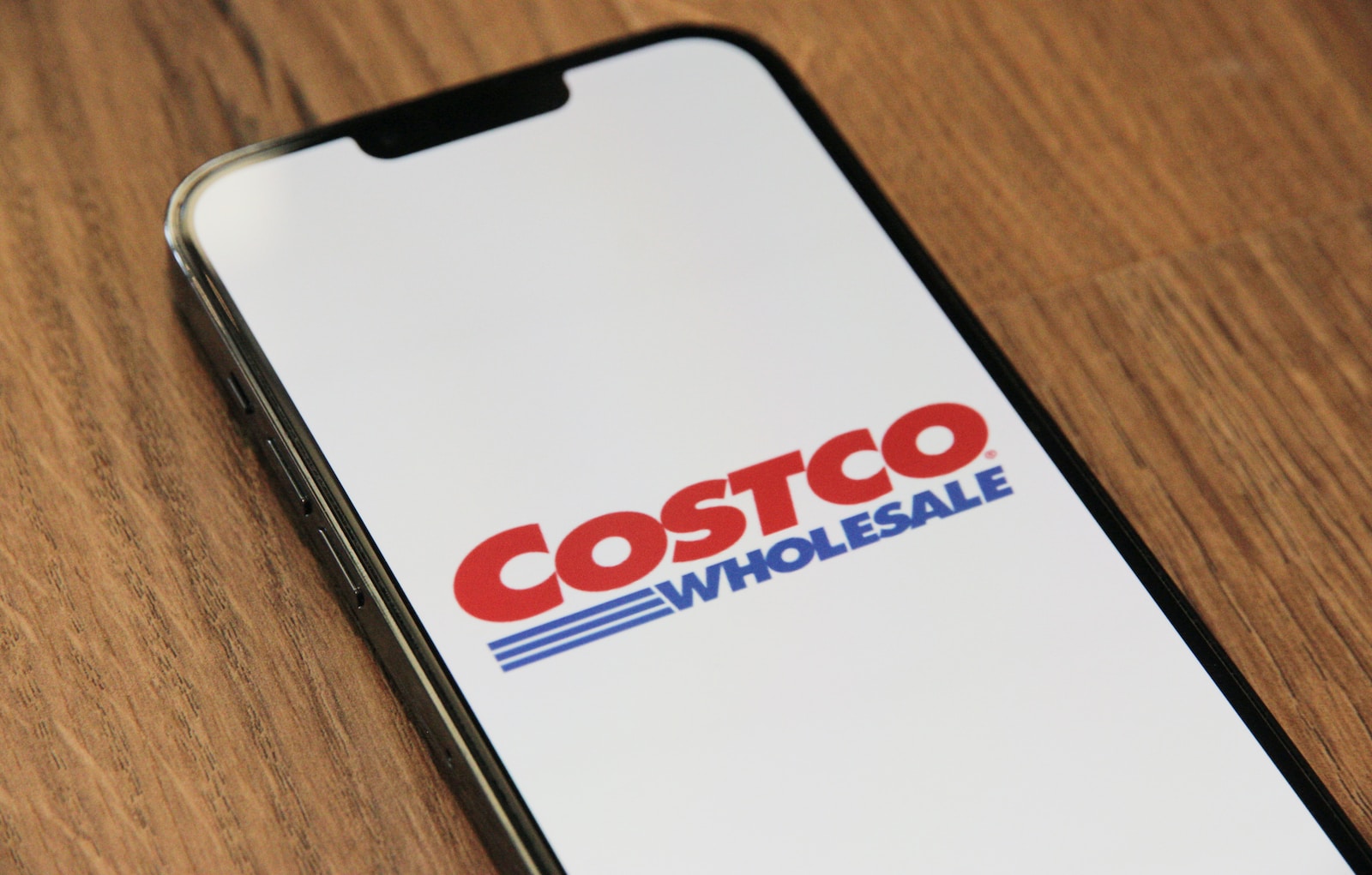 a close up of a cell phone on a table Costco logo