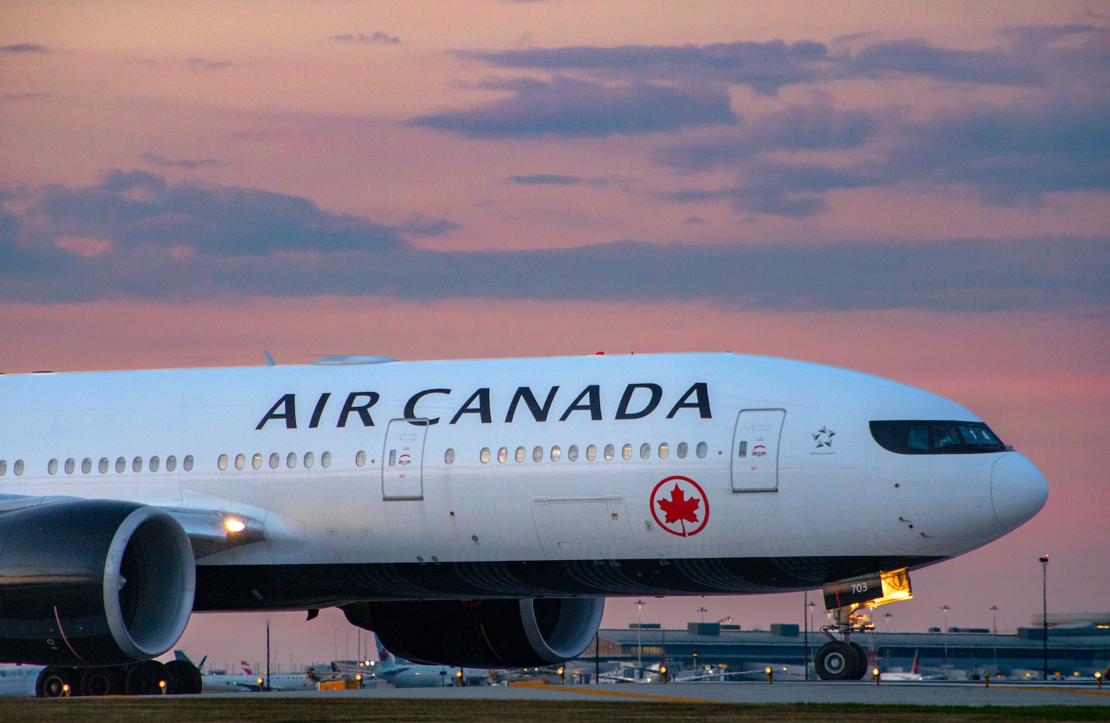 a large airplane on the runway air canada