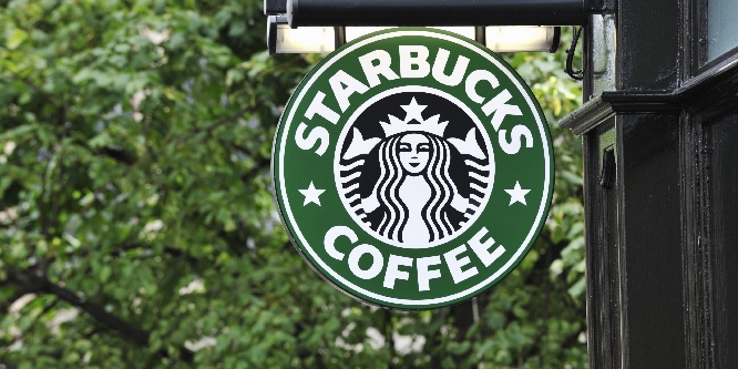 A Starbucks Coffee sign outside a Starbucks Coffee outlet on Edinburgh's Royal Mile. Starbucks Corporation is an international coffee and coffeehouse chain based in Seattle, Washington.