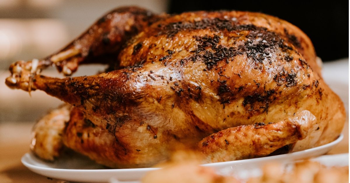 A traditional Thanksgiving turkey sitting atop a platter.