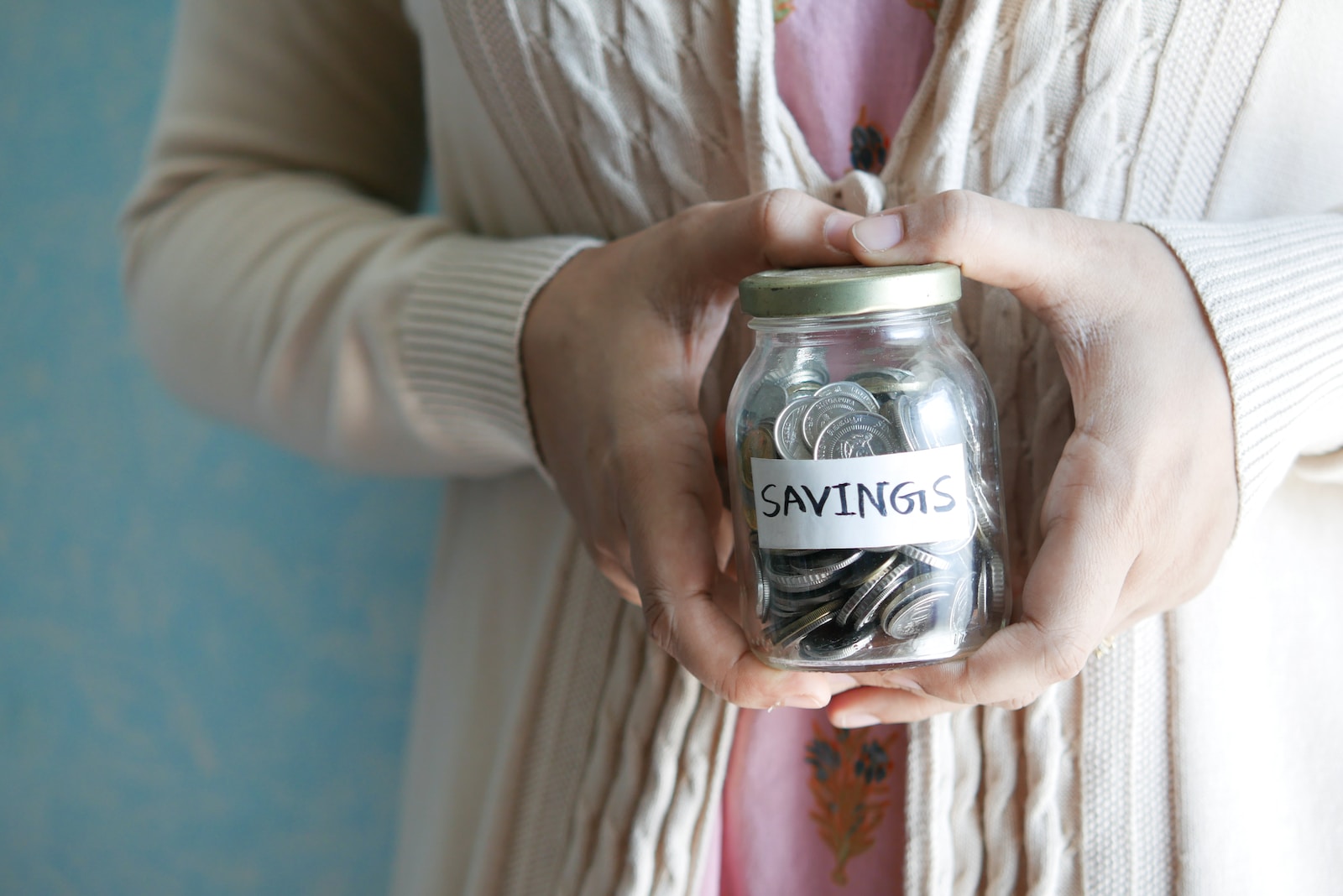 a woman holding a jar with savings written on it persistent consumer proxy
