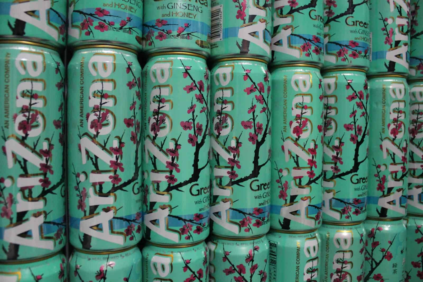 a large stack of tea cans with cherry blossoms on them