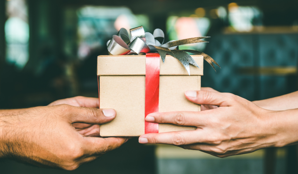 Person handing another person a gift