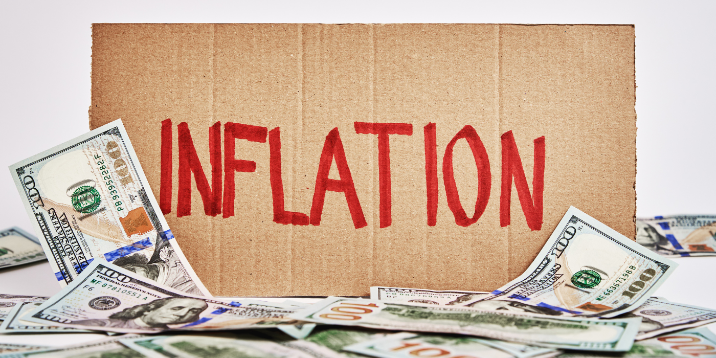 Cardboard with the word "inflation" surrounded by money