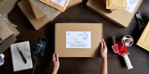 Person packing a box for a customer